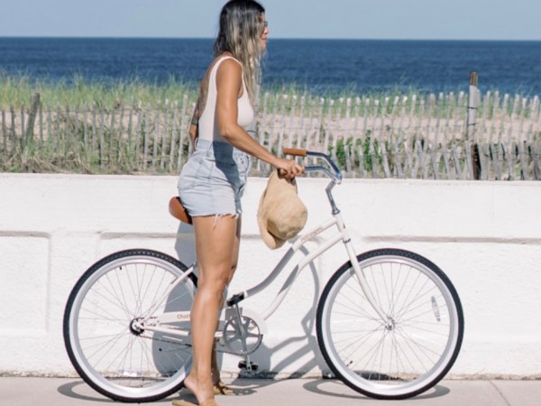 a woman riding on the back of a bicycle